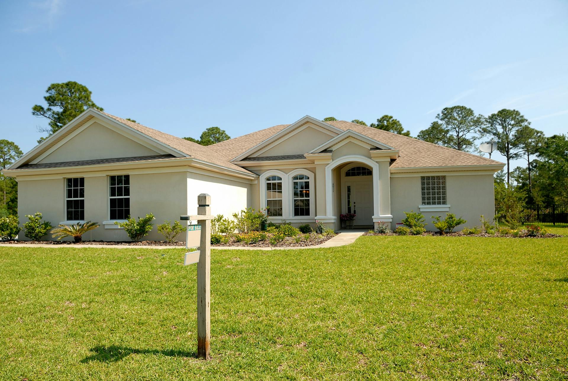 Front View of New Home with For Sale Sign in front yard.